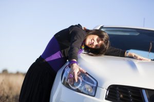 Lady hugging car
