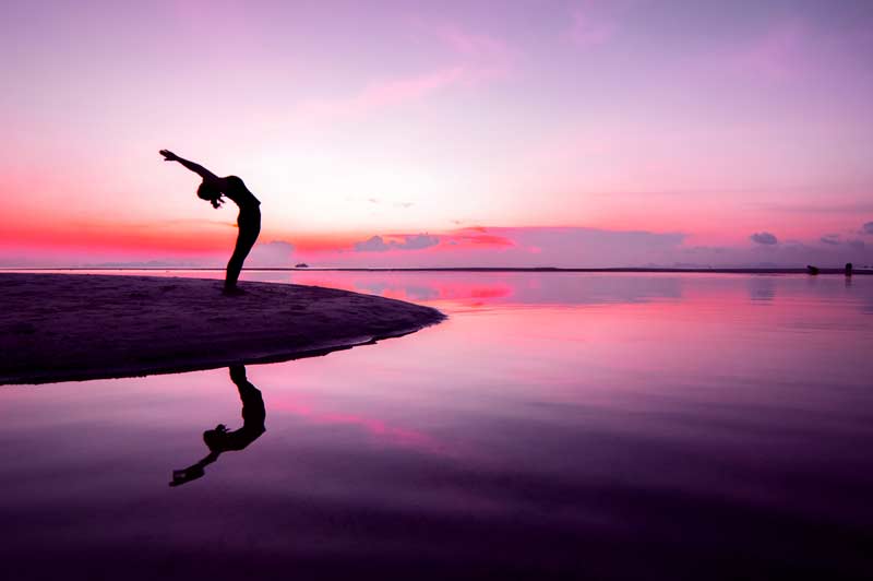 Yoga pose in front of a body of water